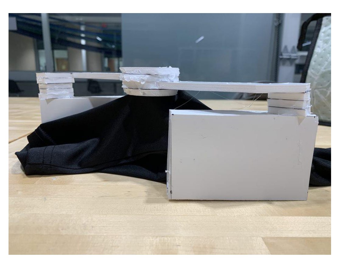 Side view of the foamboard tremor damper prototype showing riser stacks